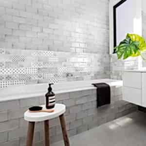 Vita Black and White Decorative Tiles - Bathroom setting with a bath and stool with toiletries