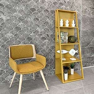 Scale Concrete Grey Scallop Shape Tiles on a wall. A lovely mustard chair and bookcase with ornaments are a focal point.