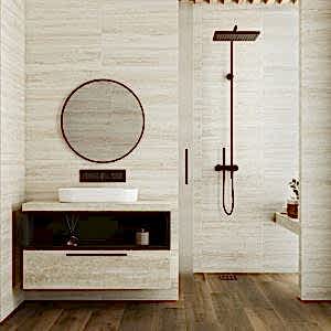 Versilia Travertine Tiles - Cream in a bathroom setting with a unti and round mirror to the left, shower to the right