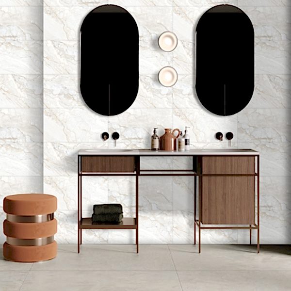 Gravel Grey and Gold Marble Tiles in a bathroom setting with a double vanity unit, twin black mirrors and warm accent lighting.