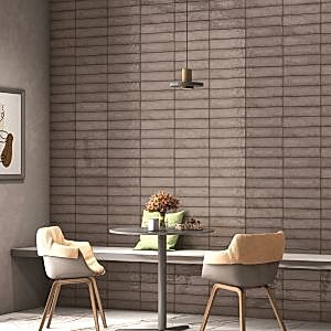Splendour Stone Grey Metro Tiles on the wall in a room with a table and chairs