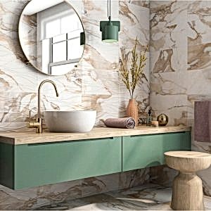 A stylish bathroom with sage green cabinetry and white and gold marble wall tiles with elegant natural accents for a serene, modern look.