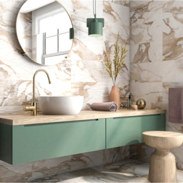 A stylish bathroom with sage green cabinetry and white and gold marble wall tiles with elegant natural accents for a serene, modern look.